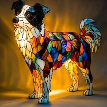 Standing border collie lamp with black and white face and a colourful patchwork body, glowing against an amber backdrop. 3