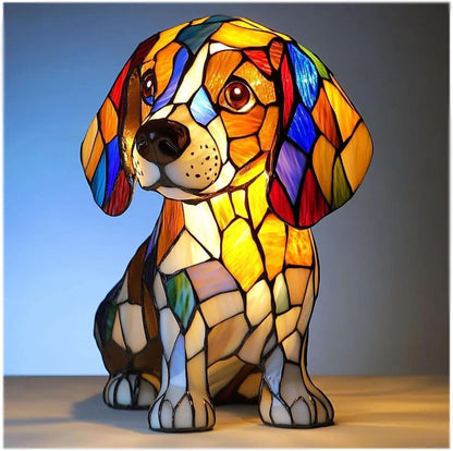 Seated beagle-style puppy lamp glowing in stained-glass panels of amber, blue, red and cream, with big brown eyes. 1