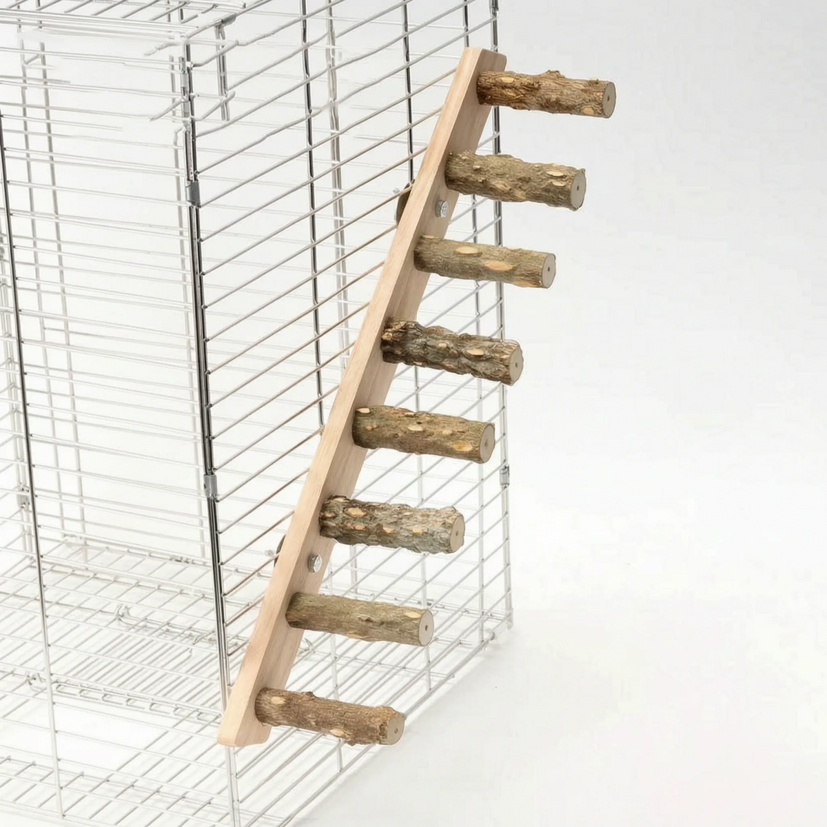Seven-rung wooden ladder with natural branch rungs fixed diagonally to the side of a wire cage. 7