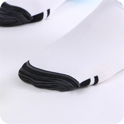 Close-up of the reinforced dark grey toe section of a white sock, with two black stripes behind the toe. 4
