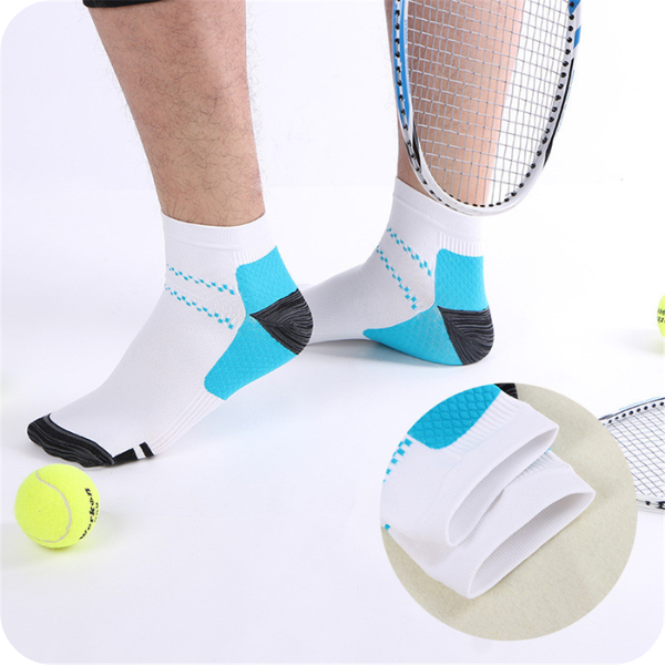 Man wearing white low-cut socks with blue heel panels while standing among tennis balls and rackets, with an inset close-up of the folded cuff. 3