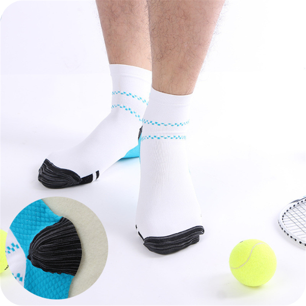 Man's feet in white ankle socks with blue dashed stripes, tennis balls and racket beside him, with a circular close-up of the heel. 2