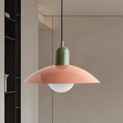 Coral-pink shade with olive-green cap and glowing globe bulb, hung beside black open shelving 10