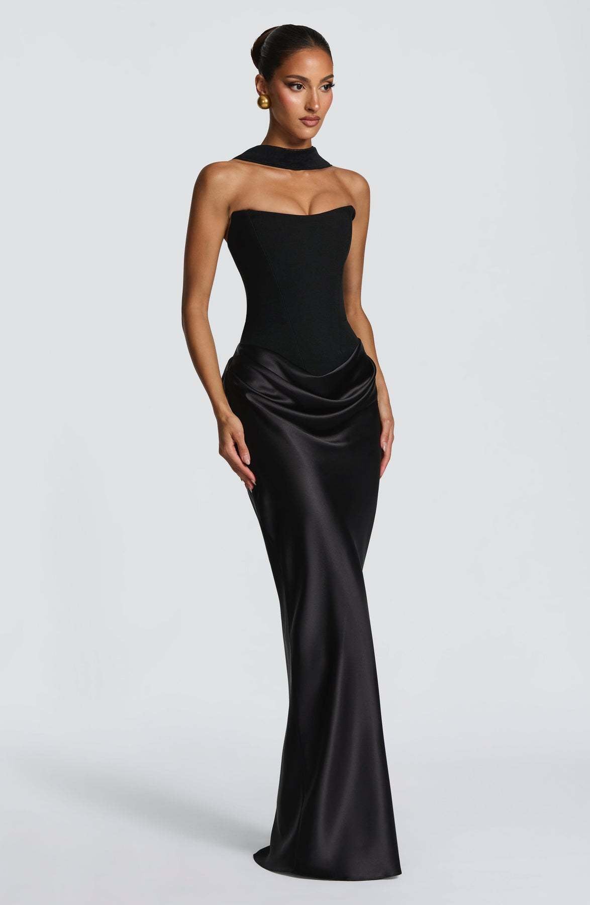 Three-quarter front view of the black dress with a choker neckline band and hip drape 22
