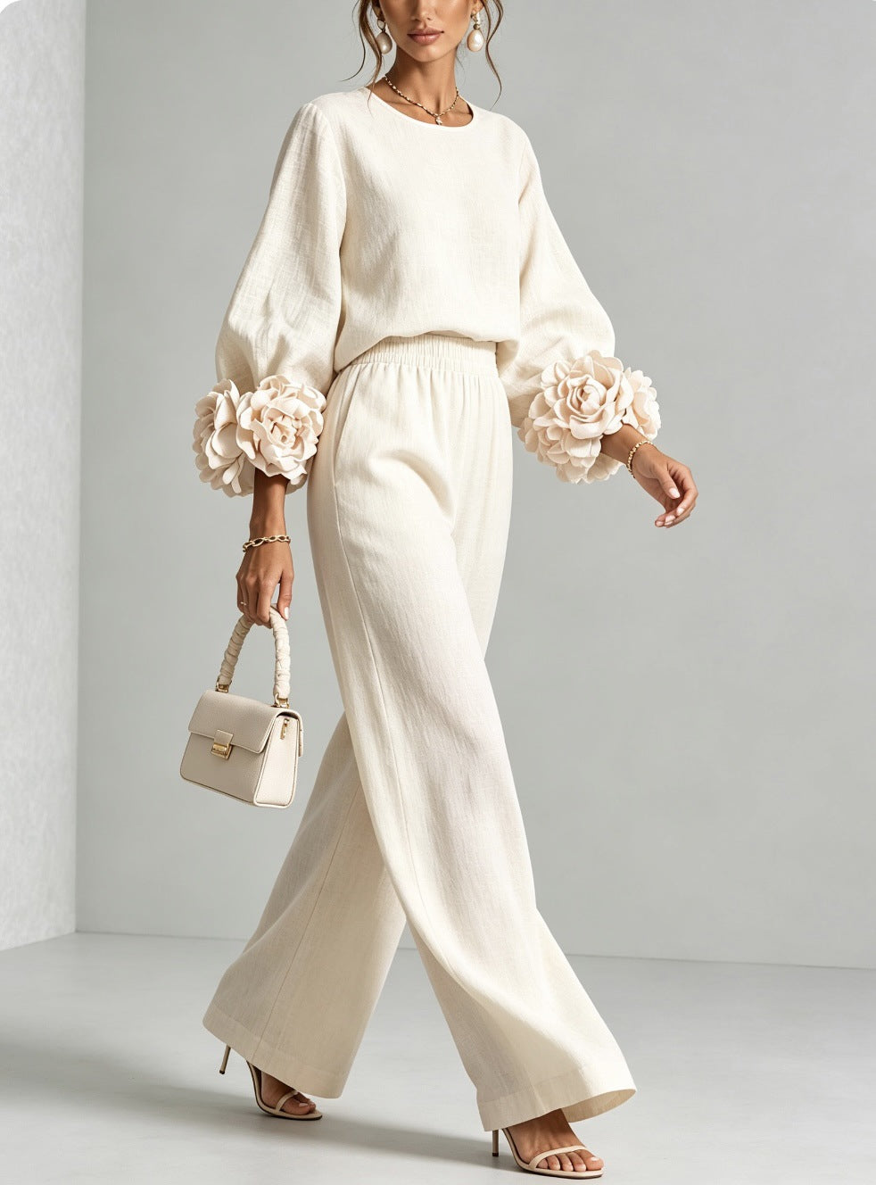 Cream version of the set worn by a model mid-stride, carrying a small structured handbag 4