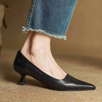 Side view of a black leather pump on a model's foot, with cropped jeans 14