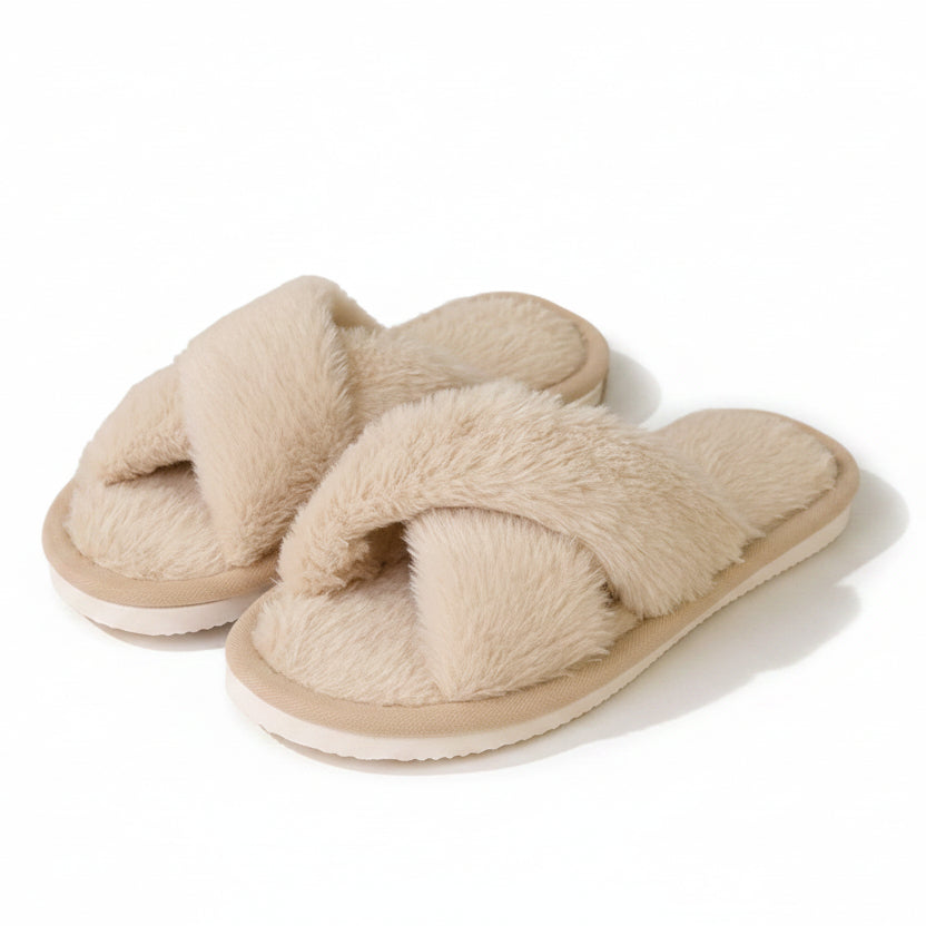 Pair of beige fluffy faux-fur slippers with crossed straps, an open toe and a pale flat sole, on a white background. 1