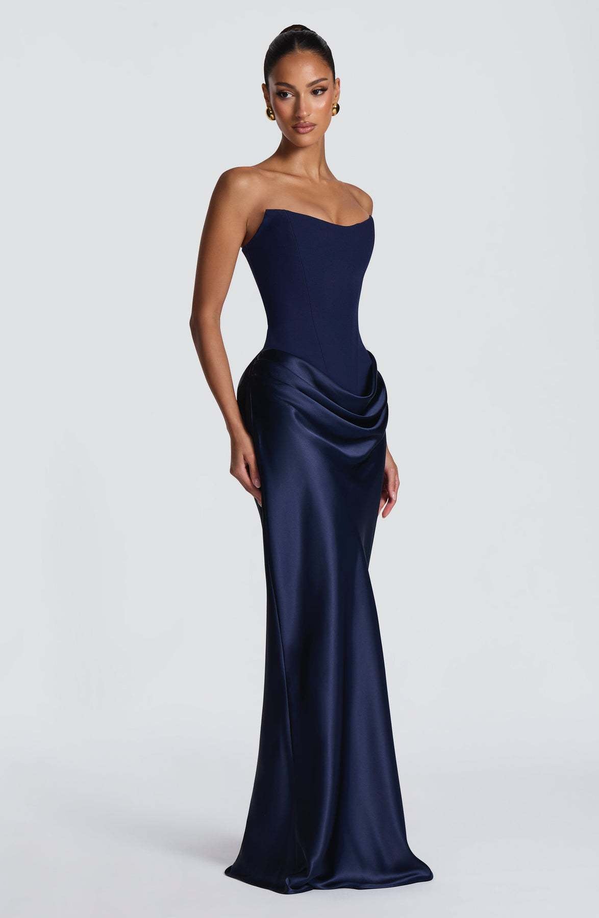 Navy corset maxi dress seen from a three-quarter angle, showing the side hip drape 8