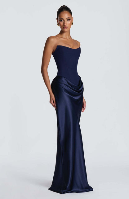 Navy corset maxi dress seen from a three-quarter angle, showing the side hip drape 8