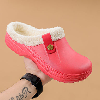Hand holding a bright red clog with cream faux fur lining against a tan background 17