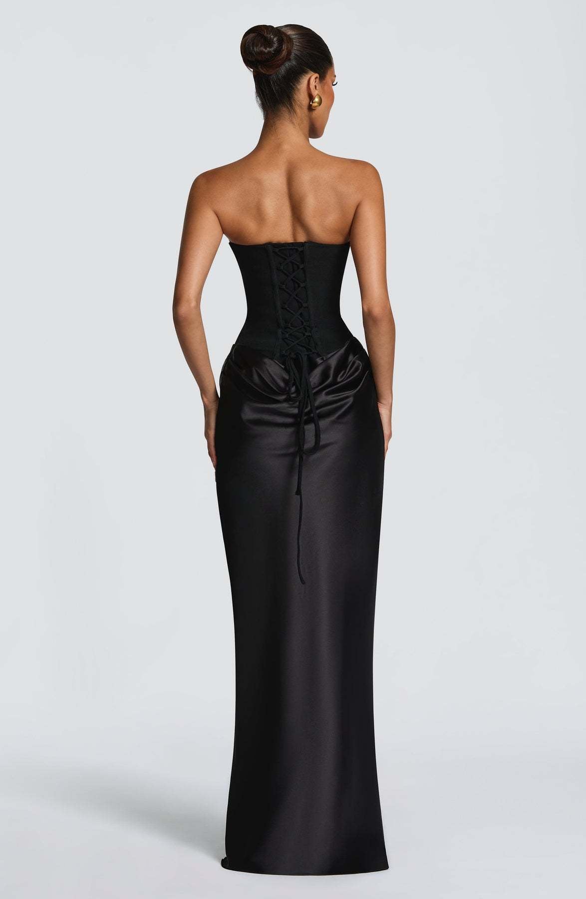 Back view of the black dress showing the corset lace-up fastening and trailing ties 23