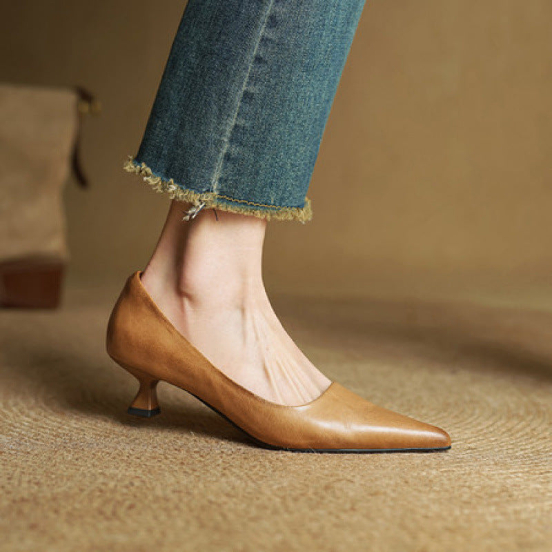 Side view of a tan leather pump on a model's foot, with jeans 4