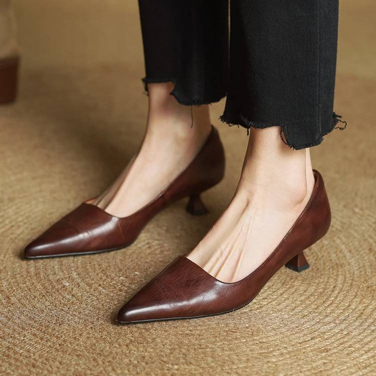 Brown leather kitten heels worn by a model with black frayed-hem trousers 18