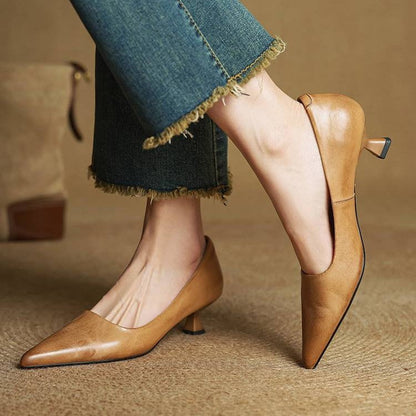 Model crossing one leg to show tan kitten heels from the side and back 3