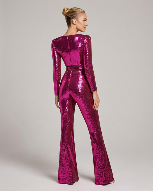 Back view of the fuchsia pink sequin jumpsuit on a model, showing the centre back seam and long sleeves. 2