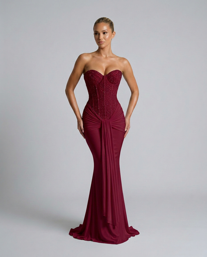 Model in the burgundy fitted mermaid-style gown with hands by her hips, showing the sparkling bodice 5
