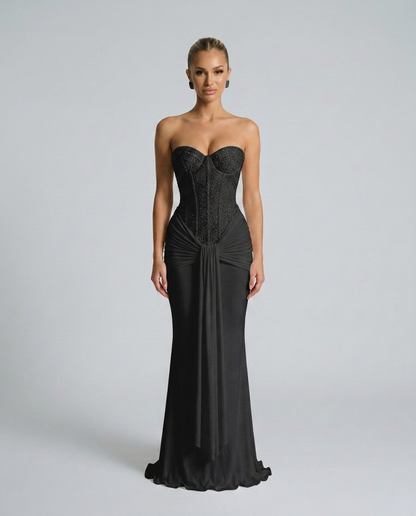 Model wearing the black beaded corset maxi dress, facing the camera, with draped front panel 1