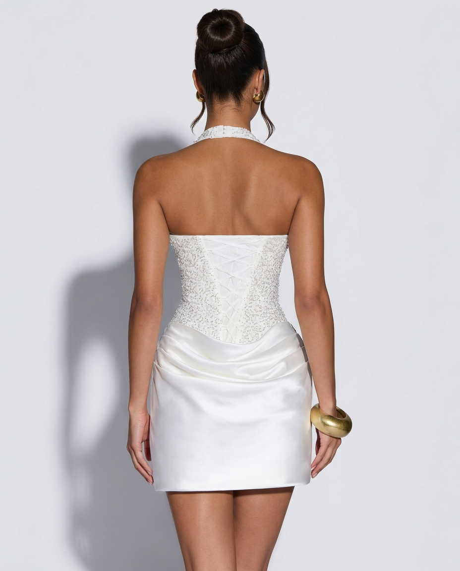 Back view of the white dress showing the lace-up corset back and beaded halter strap 5