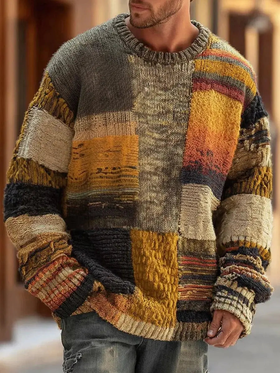 Man wearing the crew-neck jumper outdoors, showing mustard, grey, cream and rust patchwork panels with ribbed trim 1