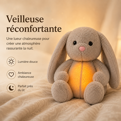 Grey bunny plush giving off a warm amber night light glow on a cream bedspread, with a softly lit background. 5