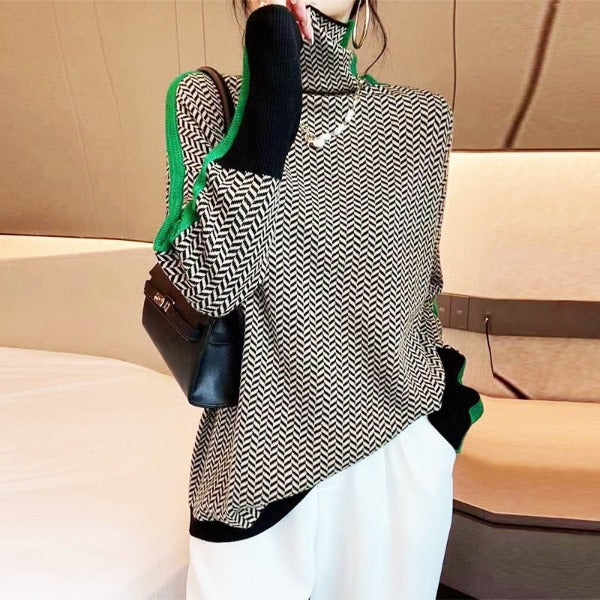 Model wearing the black and white herringbone jumper with green side stripes and black cuffs, carrying a black shoulder bag. 5