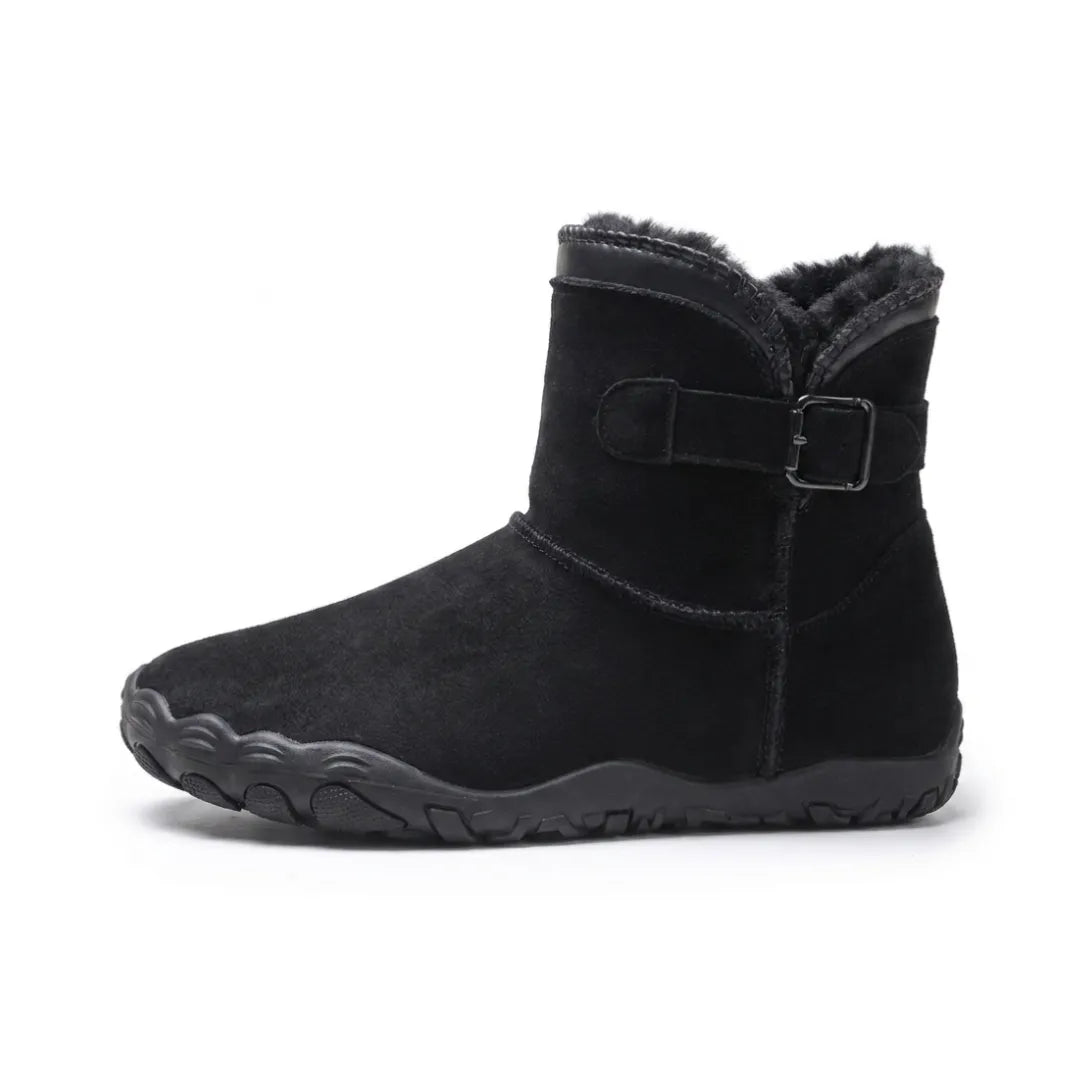 Side view of a single black suede ankle boot with dark fleece lining and buckled strap 10