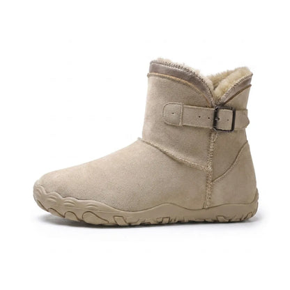 Side view of a single beige suede ankle boot with fleece lining and a buckled strap 1