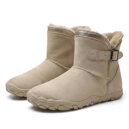 Pair of beige suede boots with fleece lining, buckled strap and wide, flexible sole 7