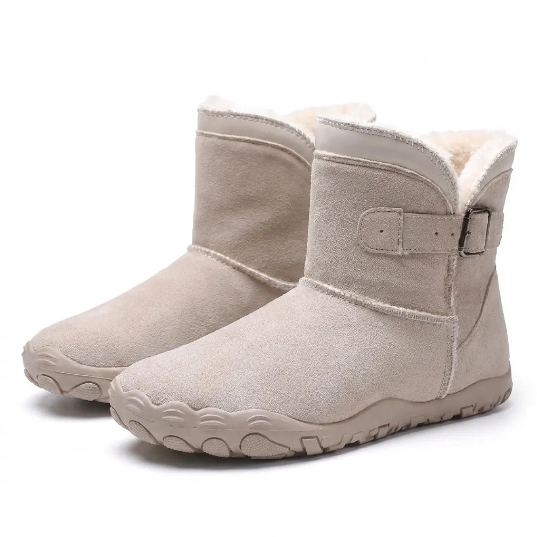 Pair of beige suede ankle boots with buckle straps, soft fleece lining and wide-toe treaded soles 34