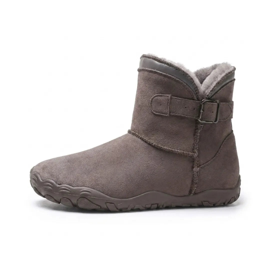 Side view of a brown-grey suede ankle boot with buckle strap, grey fleece lining and treaded sole 37
