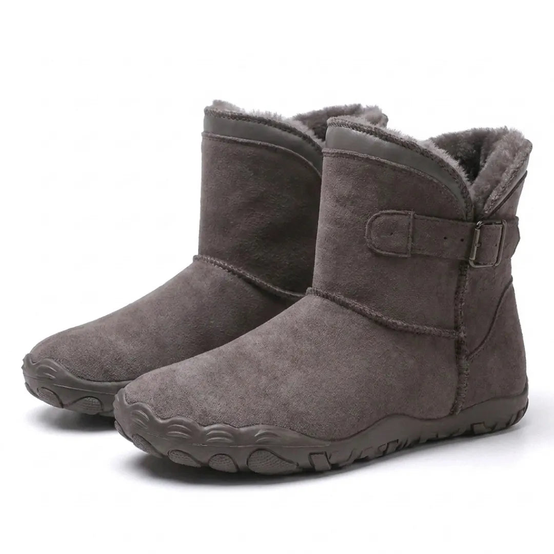 Pair of taupe suede ankle boots with fleece lining, side buckle strap and wide-toed rubber soles 43