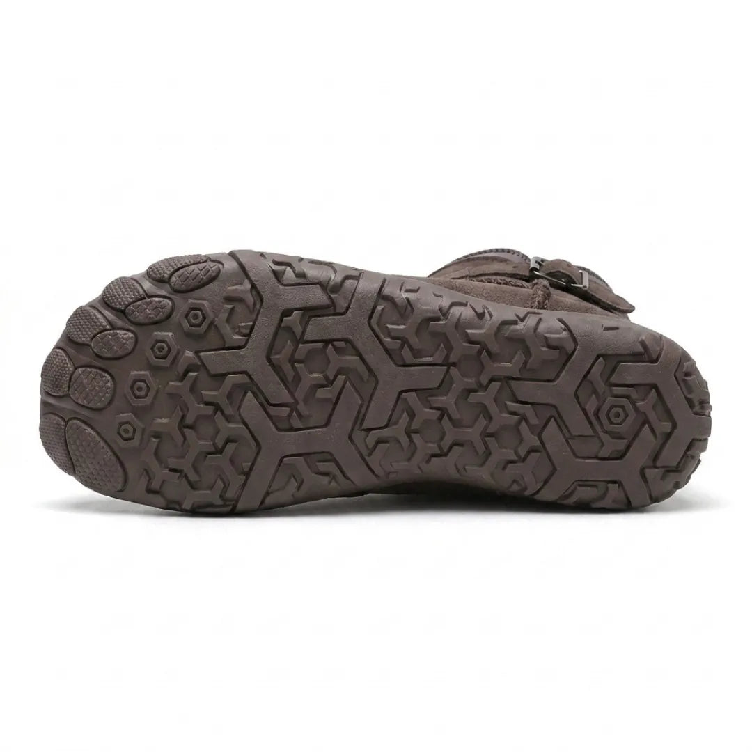 Underside of a taupe boot showing the patterned rubber outsole with hexagonal grip and separate toe pods 45