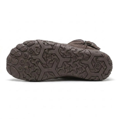Underside of a taupe boot showing the patterned rubber outsole with hexagonal grip and separate toe pods 45
