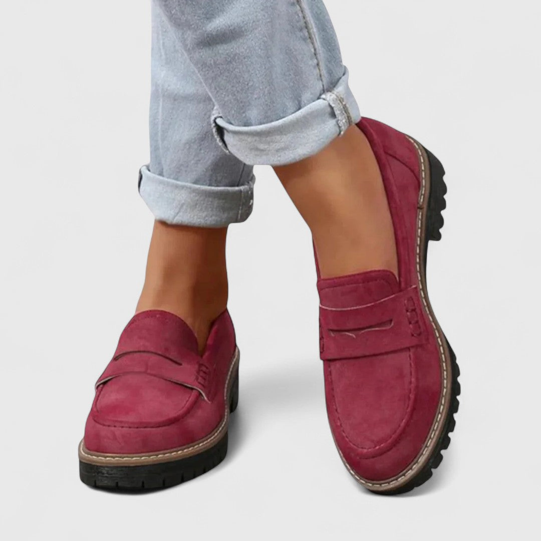 Burgundy suede-look loafers worn with turned-up light denim jeans, shown from the front 2