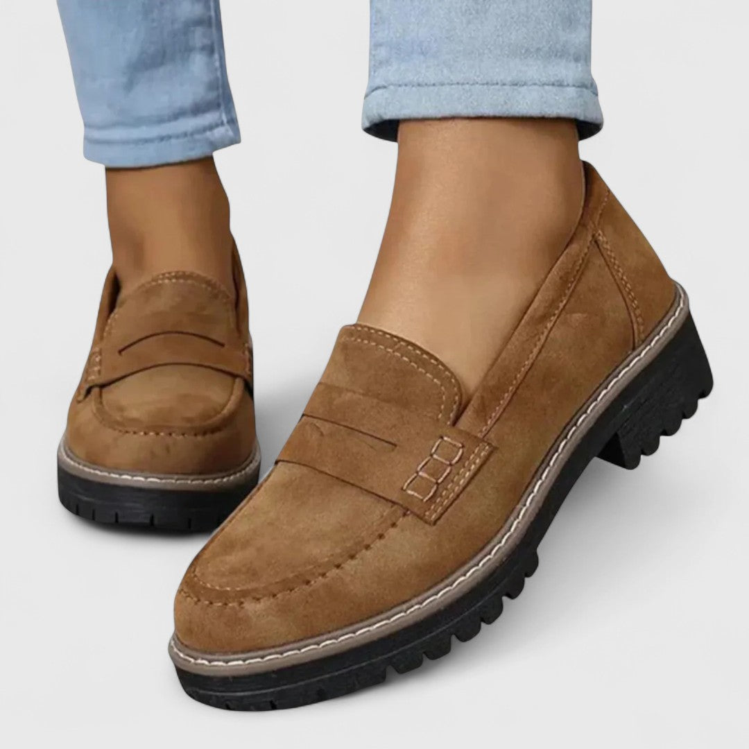 Tan brown suede-look loafers worn with light jeans, close-up of the stitched penny strap 5