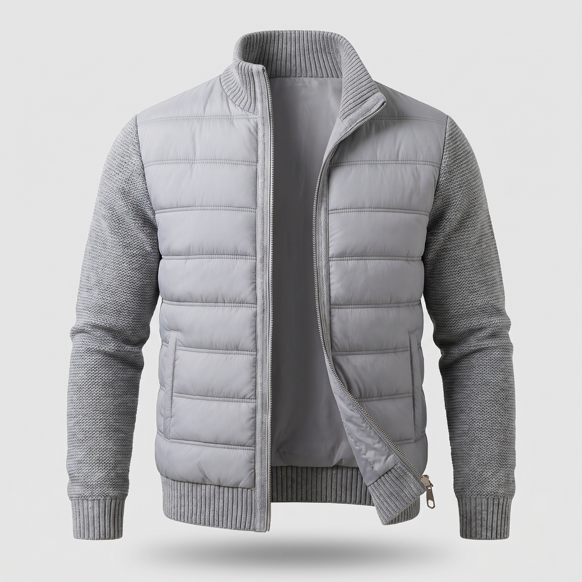 Light grey jacket laid flat from the front, zip partly open, showing quilted body and knitted sleeves 3