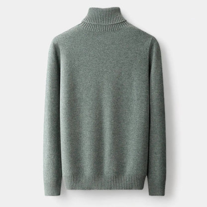 Back view of the sage green roll-neck jumper laid flat, showing the plain back and ribbed hem 2