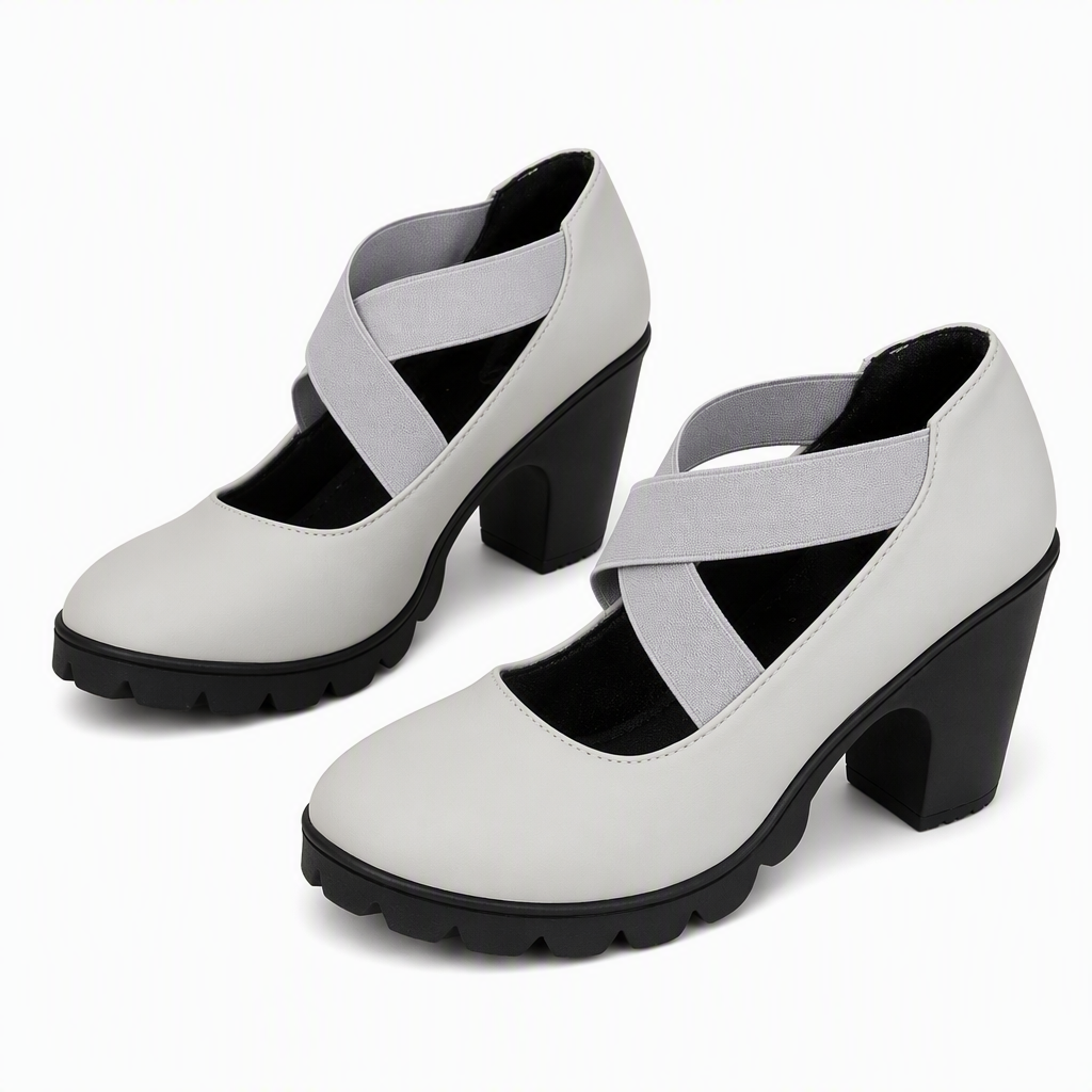 Pair of light grey block heel Mary Janes with crossed grey elastic straps and black treaded soles on a white background. 9