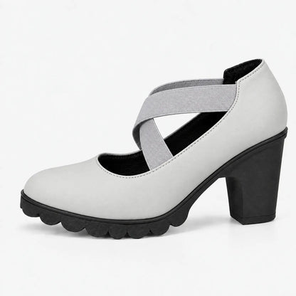 Single light grey block heel with crossed grey elastic straps and black scalloped sole, shown in side profile on white. 14