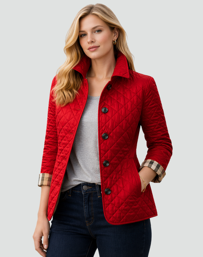 Model wearing the bright red quilted jacket with dark buttons and checked turned-back cuffs, over a grey top and dark jeans. 4
