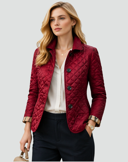 Model wearing the burgundy quilted jacket over a white blouse and navy trousers, carrying a handbag, with checked cuffs visible. 6