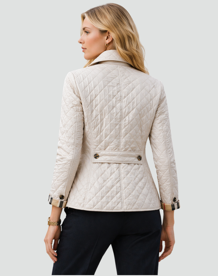 Back view of the cream quilted jacket, showing the diamond stitching, centre seam, buttoned belt tab and checked cuffs. 8