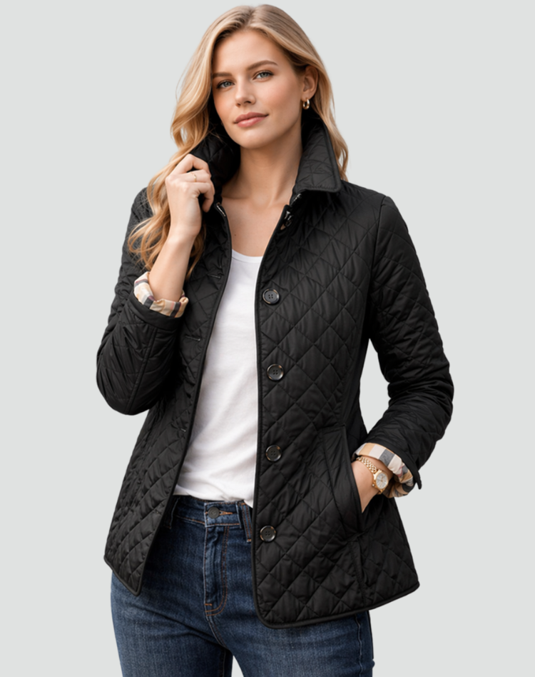 Model wearing the black diamond-quilted jacket with the collar turned up, over a white top and jeans, one hand in a pocket. 1