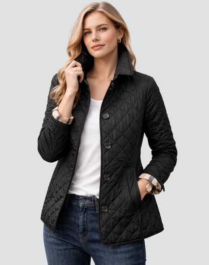 Model wearing the black diamond-quilted jacket with the collar turned up, over a white top and jeans, one hand in a pocket. 1