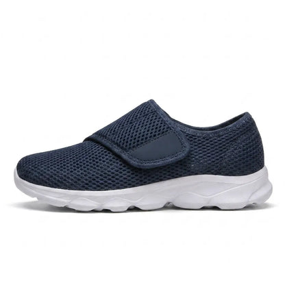 Side view of a navy mesh shoe with a wide hook-and-loop strap over the instep and a white sole. 1