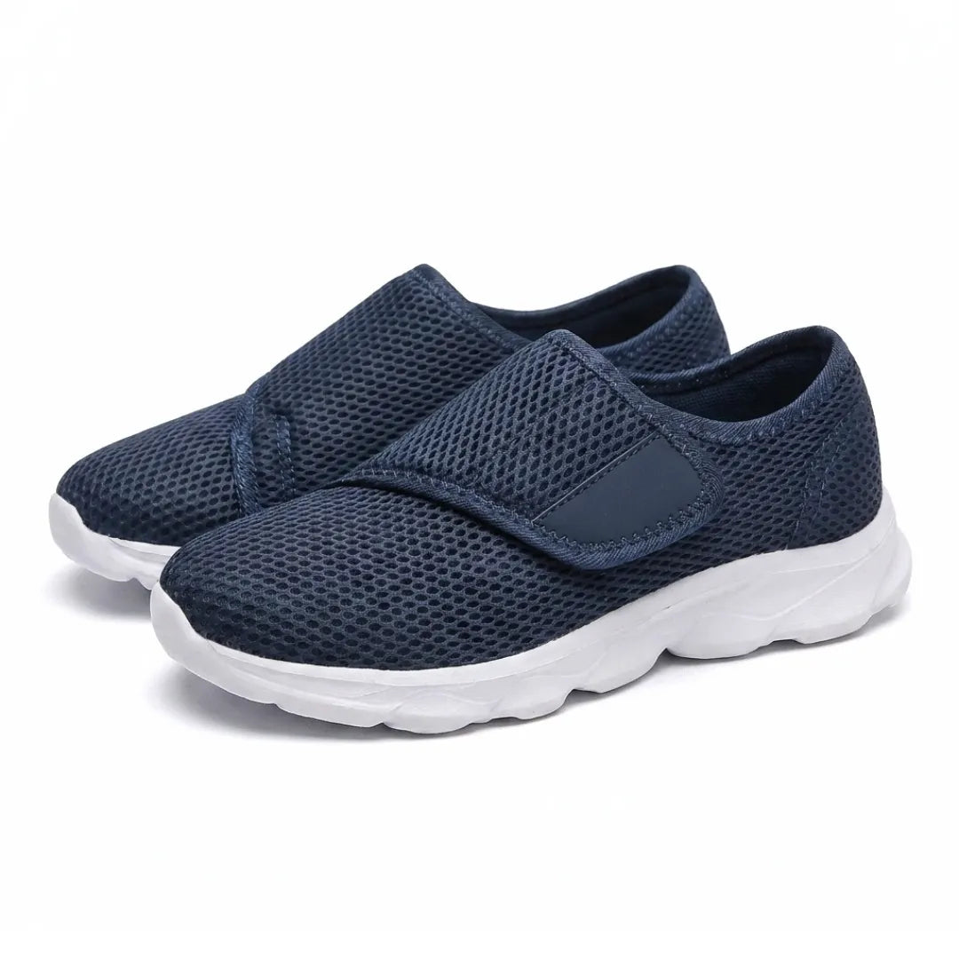 Pair of navy mesh shoes with white soles seen from the front three-quarter angle, hook-and-loop straps fastened. 7