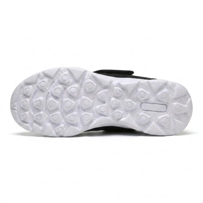 White sole of the black shoe seen from underneath, showing the grippy pattern of rounded triangular studs. 27