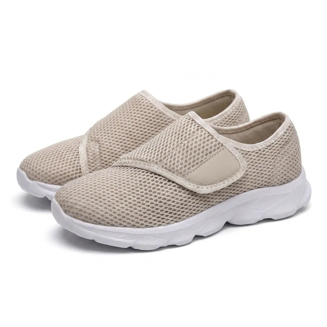 Pair of beige mesh shoes with white soles and hook-and-loop straps, seen from the front three-quarter angle. 34