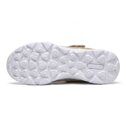 White sole of the beige shoe seen from underneath, showing the grippy pattern of rounded triangular studs. 36