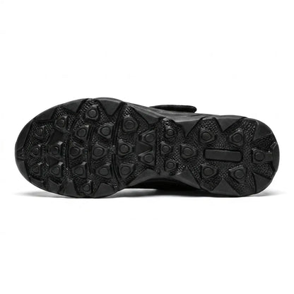 Underside of the black sole showing the raised rounded-triangle grip pattern, with the strap just visible above. 18